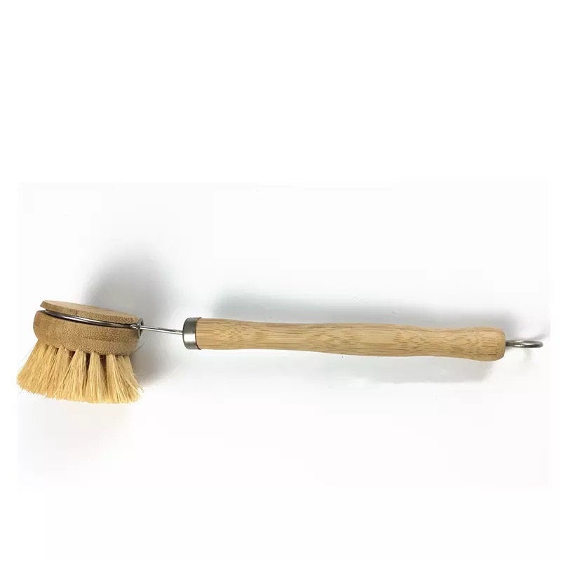 Natural bamboo dish brush with plant-based sisal bristles, shown horizontally.
